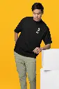 oversized-t-shirt-mockup-featuring-a-man-leaning-on-a-colorful-cube-m38921.webp